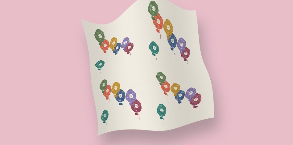 Moving pale fabric shows colourful flowers arranged in the studio